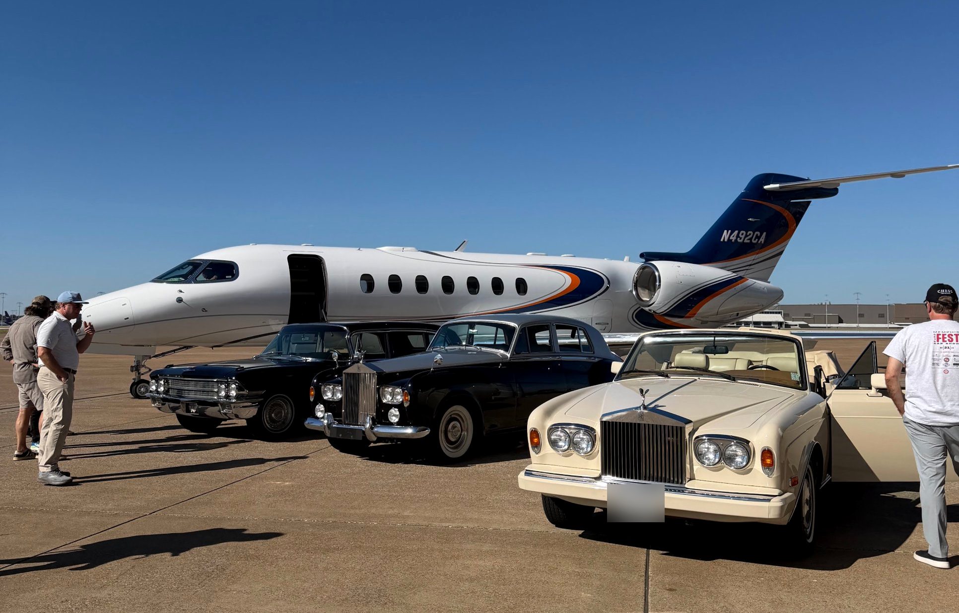 The limousine lined up with two Rolls-Royces beside a private jet on the airport ramp