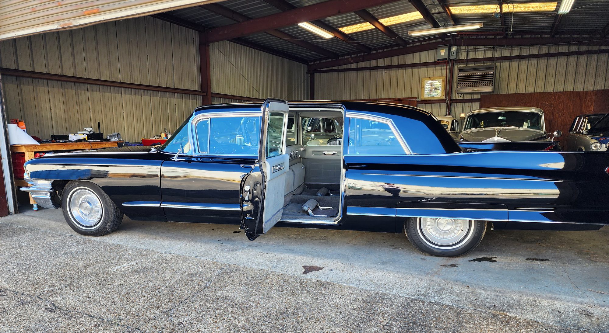 The limousine in profile with the rear door open