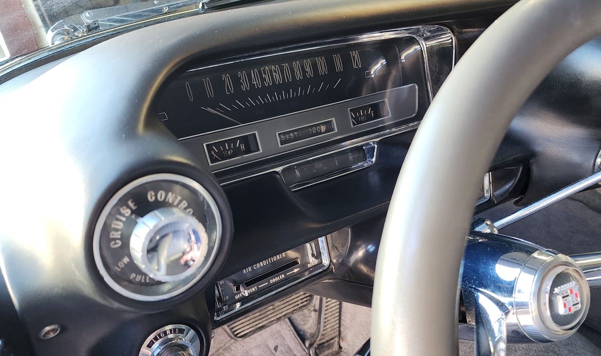 The speedometer, cruise control dial, and air conditioner controls