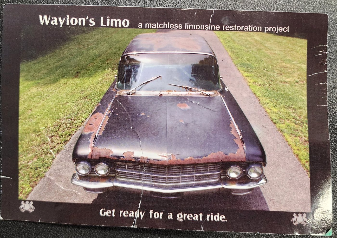 Postcard showing the limousine before restoration, rusted, front view
